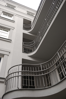 a section of the building with beautiful balconiesi